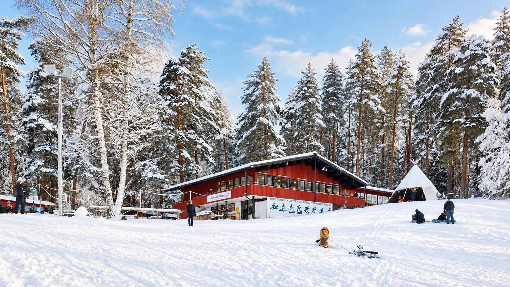 Snötäckt Sunnerstastugan med människor framför stugan